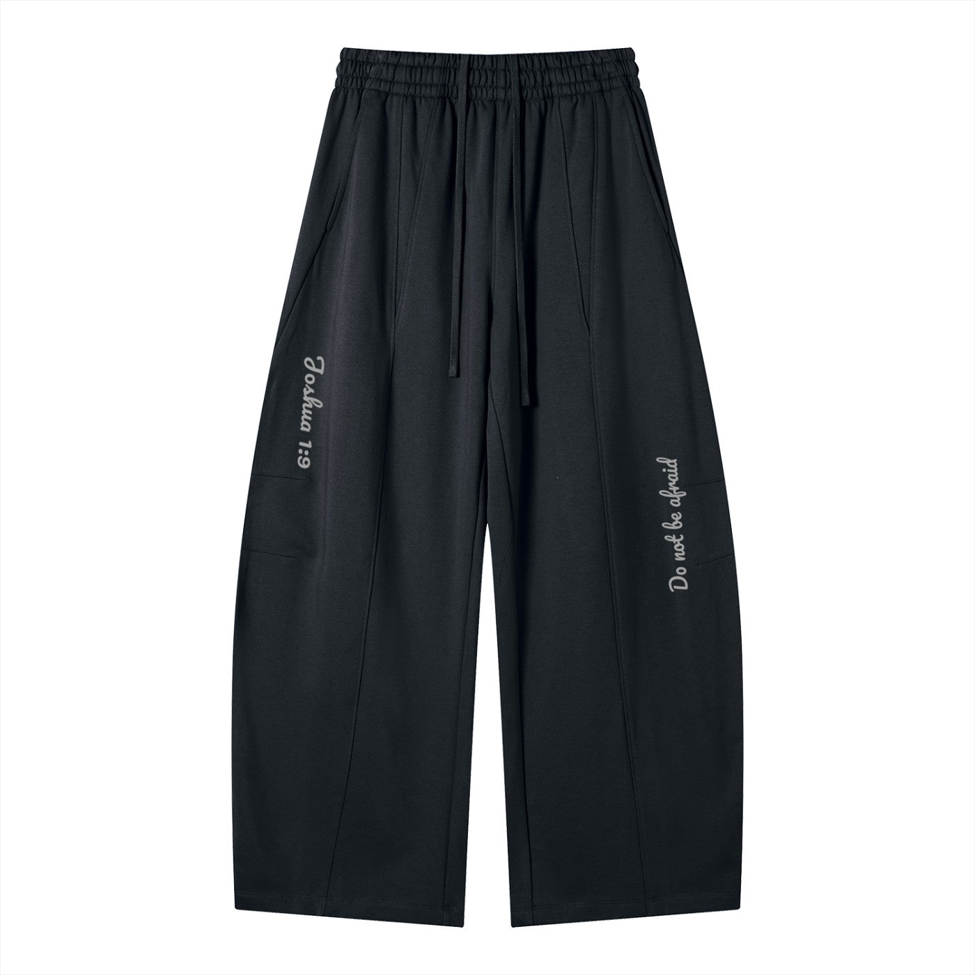 Greater Good black cotton blend wide-leg sweatpants with drawstring, elastic waist, and printed text "Joshua 1:9" and "Do not be afraid".